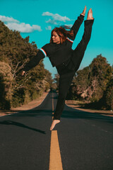 ballet dancer jumping on the road