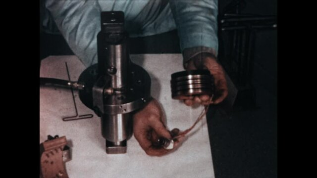 Solenoid Assembly 1967 - A technician demonstrates the assembly of an industrial solenoid in 1967.