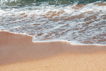 Close up, beach with small waves and clean sand