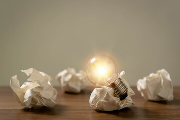 hand holding a light bulb.Communicating the emergence of creative business ideas or learning..