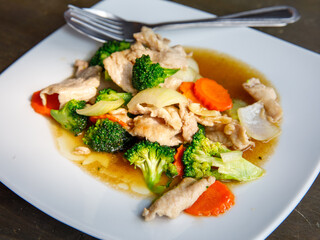 Broccoli stir fried with pork in oyster sauce, thai healthy food. Close up, selective focus