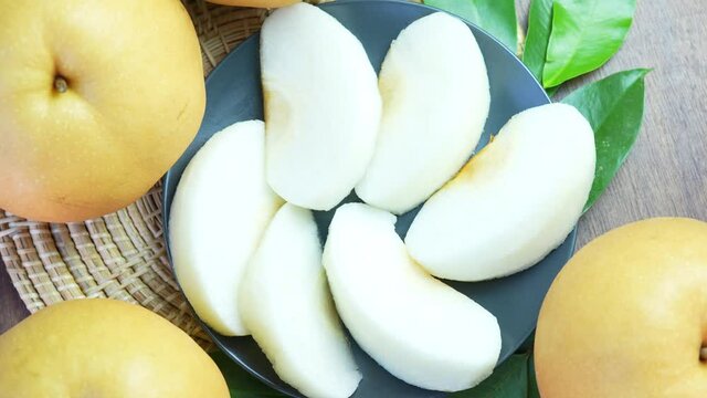 Snow pear fruit on wooden background, Fresh Nashi pear or Korean pear fruit rotation.
