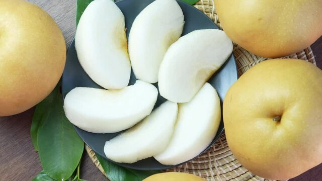 Snow pear fruit on wooden background, Fresh Nashi pear or Korean pear fruit rotation.