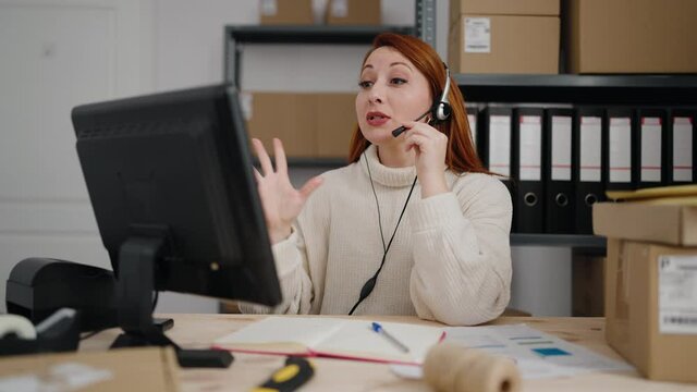 Young redhead woman call center agent having speaking at office