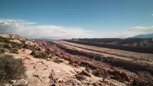 A daytime time-lapse of the Waterpocket Fold, a 100-mile long geological feature in Capitol Reef National Park in Utah. Clouds move west to east towards the Henry Mountains.