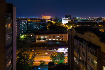 Fototapeta na wymiar Beautiful aerial view of illuminated apartment buildings and the Regional Clinic Hospital №2 on the Harkovskaya Street in summer day at dusk, Tyumen, Russia 