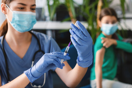 Doctor With Syringe Taking Dose Of Covid-19 Vaccine From Bottle