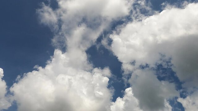 Navy blue sky background n fluffy cumulus white clouds