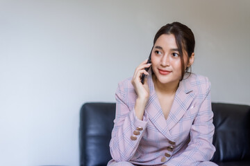 woman sitting on the sofa talking on the phone