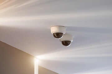 CCTV security camera mounted on a white ceiling.