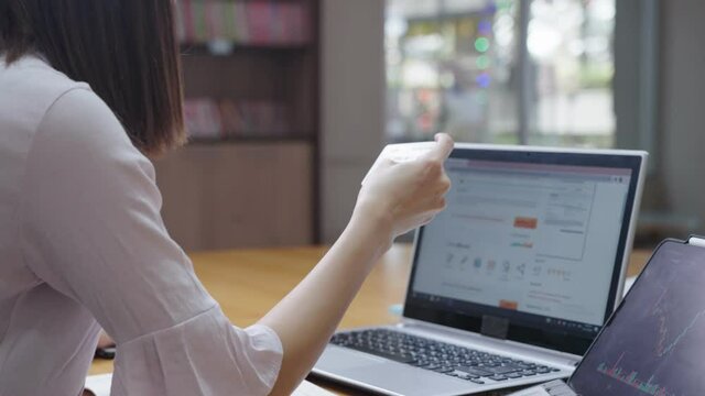 Female office worker doing an online hotel reservation by fulfilling a personal information on website form, online banking shopping and lifestyle, surfing on internet, wireless convenient technology