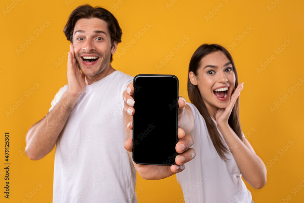 Poster couple showing blank empty smartphone screen for mockup