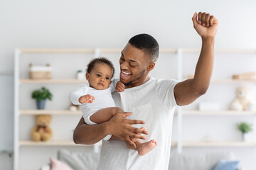 Fototapeta premium Hapiness Of Fatherhood. Joyful Black Dad Enjoying Spending Time With Infant Child