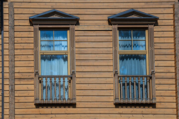 Detail of Ukrainian traditional rural wooden house, background exterior facade with windows frame. Ukraine