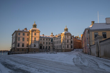 Old court houses with towers and statue on the island Riddarholmen a sunny and snowy winter day in Stockholm