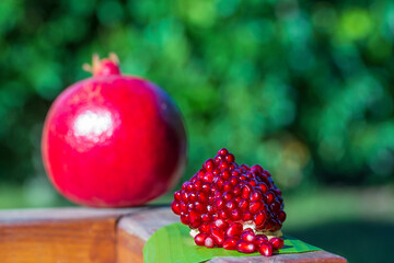 Ripe pomegranate fruit segment . Organic, fresh, red garnet close up