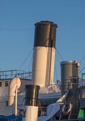 Chimneys of old steam boats a sunny winter day in Stockholm