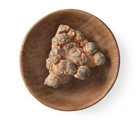 Dried notoginseng root in the wooden bowl, isolated on white background, top view