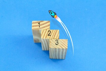 a block of wood with 1 2 3 with a rocket launch. Business startups, new ideas and new project...