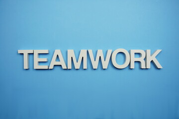 Teamwork alphabet letters on blue background