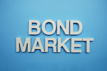 Fototapeta na wymiar Bond Market alphabet letters on blue background