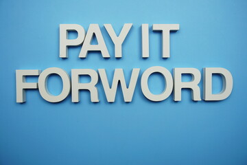 Pay it Forward alphabet letters on blue background