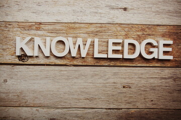 Knowledge alphabet letters on wooden background