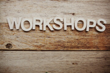 Workshops alphabet letters on wooden background