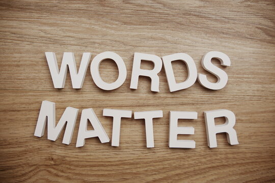 Words Matter alphabet letters on wooden background