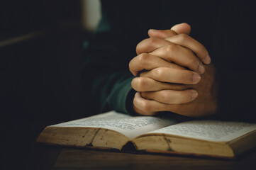 Man worship pray for god blessing to wishing have a better life. Man hands holding praying to god with the bible. christian life crisis prayer to god concept