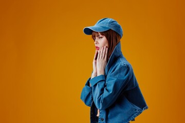 Portrait of a charming lady denim cap red lips glamor fashion yellow background unaltered