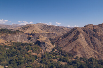 Armenia mountain gorge autumn view. Dry land mountain range a picturesque landscape view with blue sky. Stock photography.