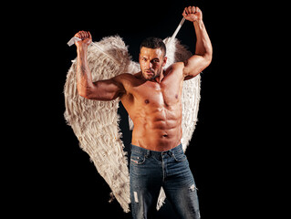 Sexy angel cupid man with angels wings and naked muscular body for Valentines Day.