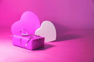 pink gift box with pink ribbon and hearts