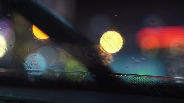 Rain falling on the windshield of the car. View from inside the car,