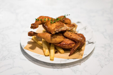 There is a whole roast chicken on the table