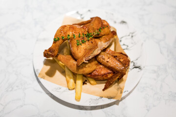 There is a whole roast chicken on the table