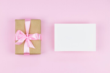 Blank paper card mock up on pink background with present 