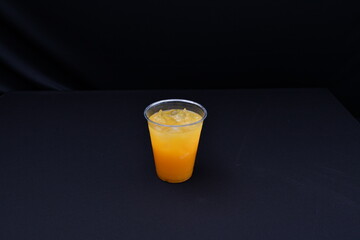 Orange juice against a plain black background