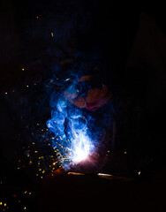 Welding flame while working with a semi-automatic welder.