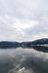 A view of Lake Yogo in Shiga Prefecture in midwinter, with the sky reflecting off the lake surface.