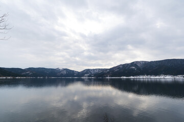 A view of Lake Yogo in Shiga Prefecture in midwinter, with the sky reflecting off the lake surface.