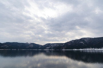 A view of Lake Yogo in Shiga Prefecture in midwinter, with the sky reflecting off the lake surface.