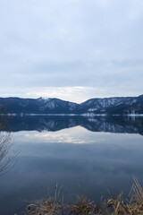 A view of Lake Yogo in Shiga Prefecture in midwinter, with the sky reflecting off the lake surface.
