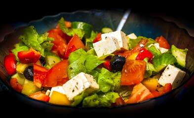 Greek Salad close-up on a black background