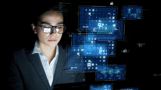 Young woman watching hologram screens. Data analysis. Science technology.