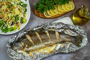 Oven baked trout in foil and salad.