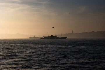 Moody Istanbul background. Silhouette of ferry and cityscape of Istanbul.