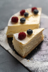 Cheesecake with fresh berries for dessert - healthy organic berry dessert cheesecake. Copy space. Homemade cheese cake. Selective focus. Vertical shot