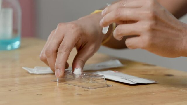4K, Close Up Man's hand preparing used a rapid antigen test kit to self-test the COVID-19 epidemic at home